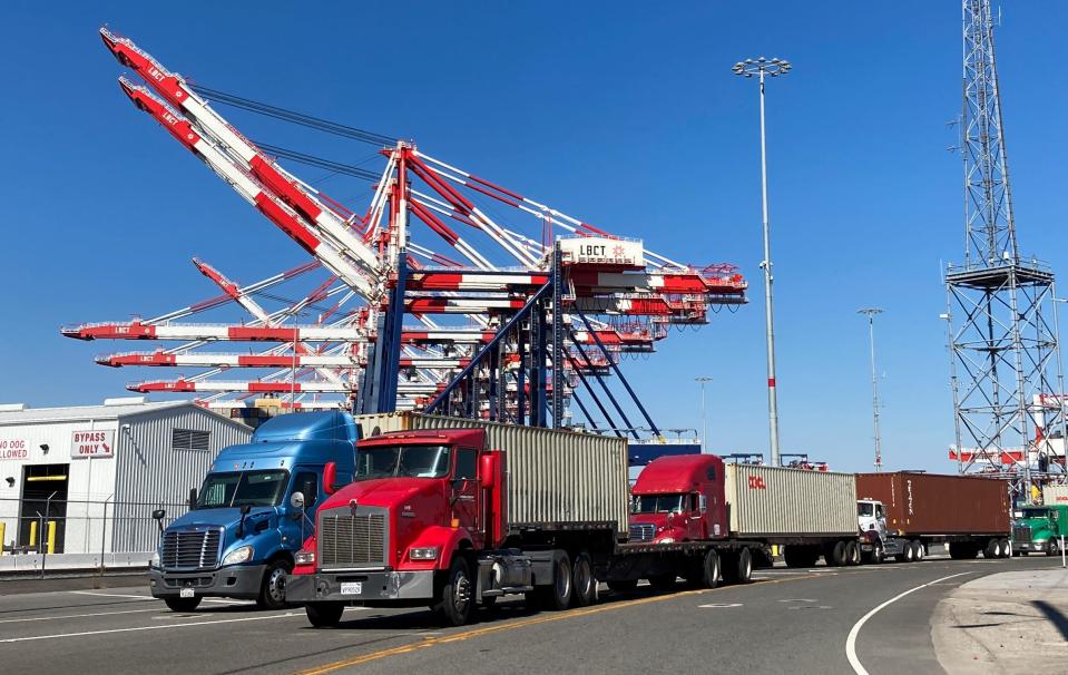 More than 100 trucks were lined up waiting to enter a terminal at the Port of Long Beach, Calif., to pick up container goods on a recent afternoon. They are part of a supply chain that has been slowed substantially by clogs in the shipping system.