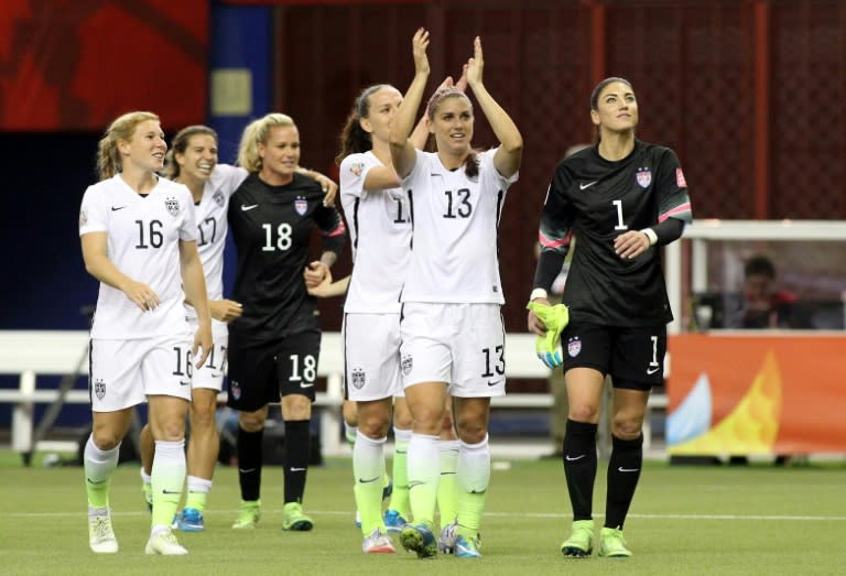 Alex Morgan (C) and Hope Solo (R) of the US celebrate with teammates their 2-0 victory against Germany, during the FIFA Women's World Cup, at Olympic Stadium in Montreal, Canada, on June 30, 2015