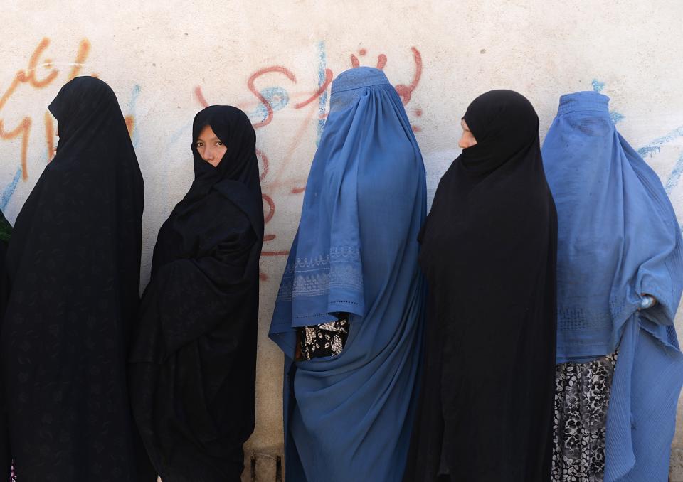 Voters line up at a polling station in Kabul on June 14, 2014.