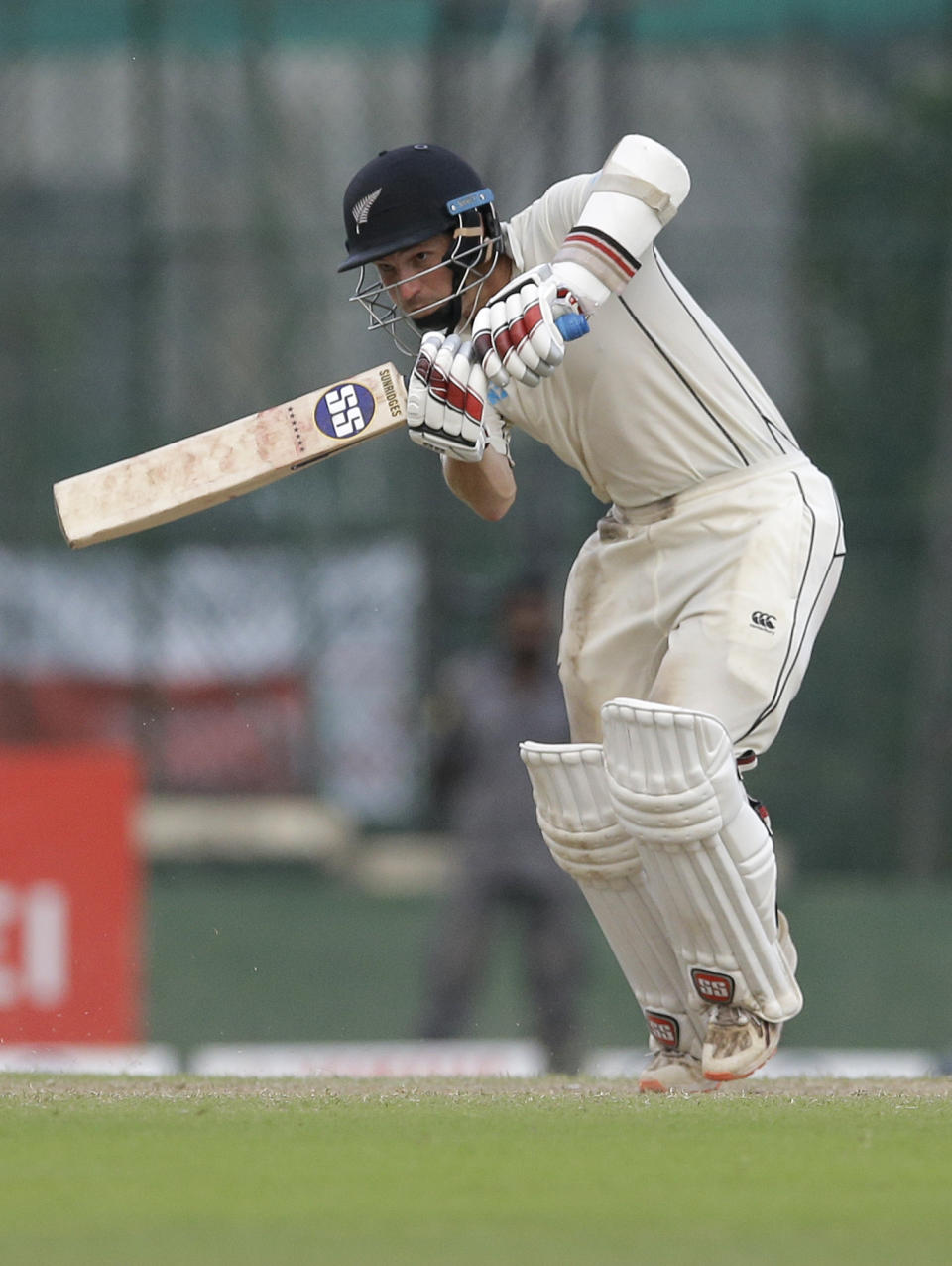 New Zealand's BJ Watling plays a shot as Sri Lanka's Lahiru Thirimanne watches during day four of the second test cricket match between Sri Lanka and New Zealand in Colombo, Sri Lanka, Sunday, Aug. 25, 2019. (AP Photo/Eranga Jayawardena)