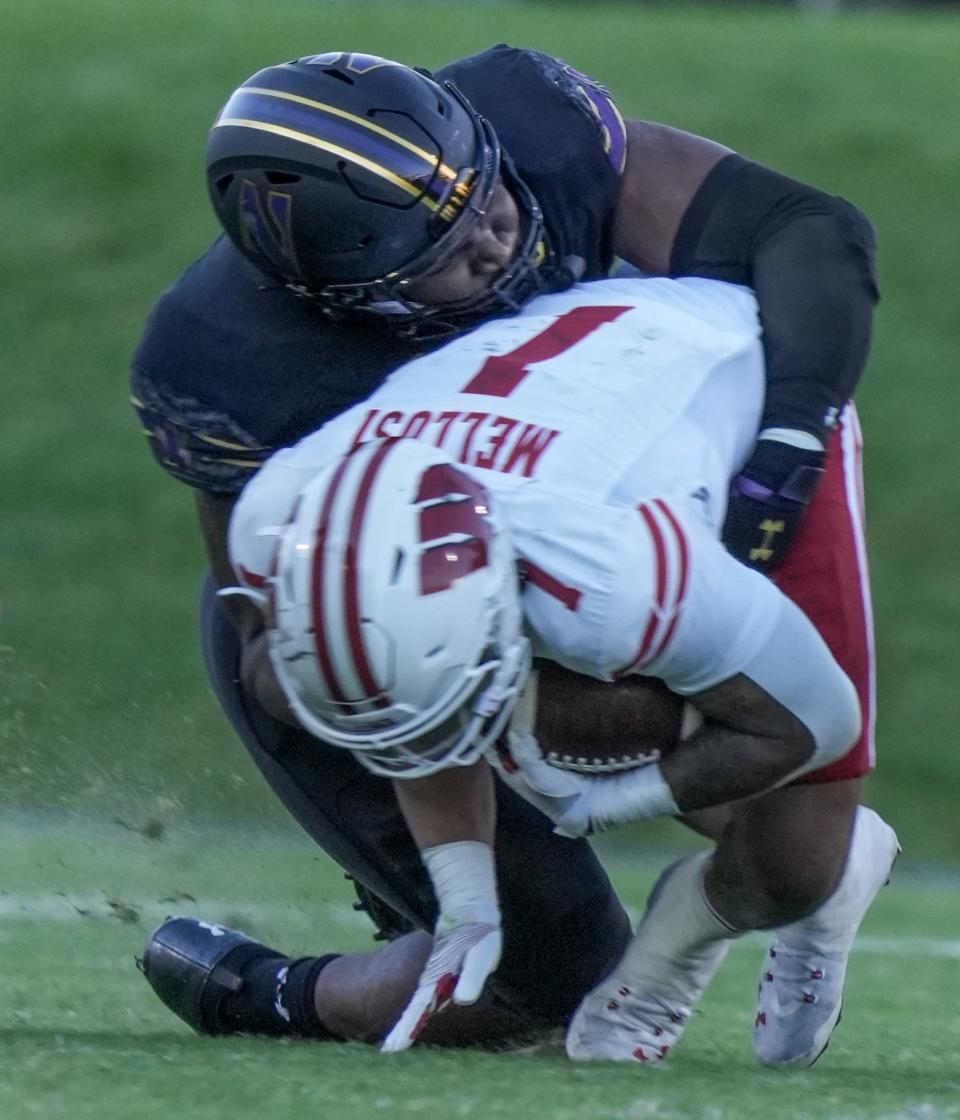 Northwestern Wildcats defensive back Theran Johnson (10) tackles Wisconsin Badgers running back Chez Mellusi during the second half of their game Saturday, Oct. 8, 2022, at Ryan Field in Evanston, IL. The Badgers defeated the Wildcats 42-7.