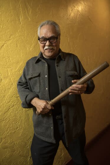 Playwright Luis Valdez holds a police baton, used in the 1943 Zoot Suit riots