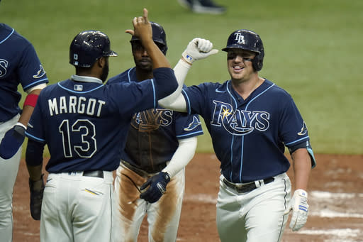 Tampa Bay Rays' Hunter Renfroe celebrates with teammates, including Manuel Margot (13), after Renfroe hit a grand slam off Toronto Blue Jays starting pitcher Hyun-Jin Ryu during the second inning of Game 2 of an American League wild-card baseball series Wednesday, Sept. 30, 2020, in St. Petersburg, Fla. (AP Photo/Chris O'Meara)