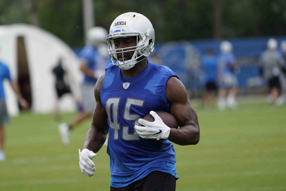 FILE - Detroit Lions linebacker Jason Cabinda (45) runs the ball during an NFL football practice in Allen Park, Mich., in this Thursday, June 10, 2021, file photo. The Detroit Lions are counting on converted linebacker Jason Cabinda to play a key role on offense under first-year coach Dan Campbell. (AP Photo/Paul Sancya, File)