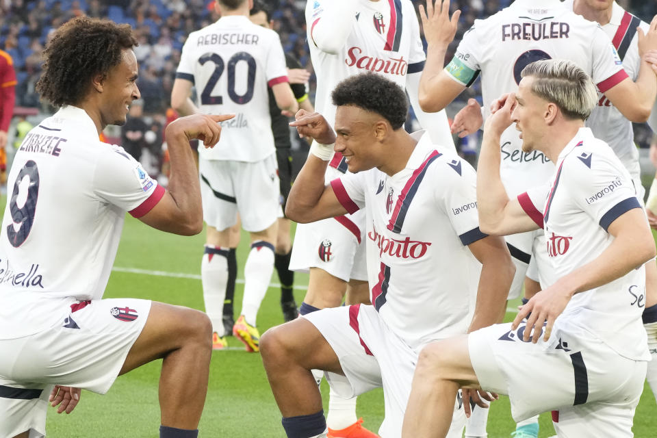 Bologna's Joshua Zirkzee, right, celebrates with his teammates Alexis Saelemaekers, right, and Dan Ndoyeafter scoring the second goal against Roma during the Italian Serie A soccer match between Roma and Bologna at Rome's Olympic Stadium, Monday, April 22, 2024. (AP Photo/Gregorio Borgia)