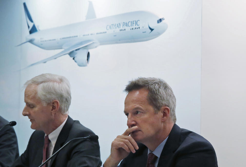 In this March 15, 2017, photo, Cathay Pacific Chief Operating Officer Rupert Hogg, right, and Chairman John Slosar attend a news conference as they announce the company result in Hong Kong. Hogg resigned Friday, Aug. 16, 2019, following pressure by Beijing on the Hong Kong carrier over participation by some of its employees in anti-government protests. (AP Photo/Kin Cheung)