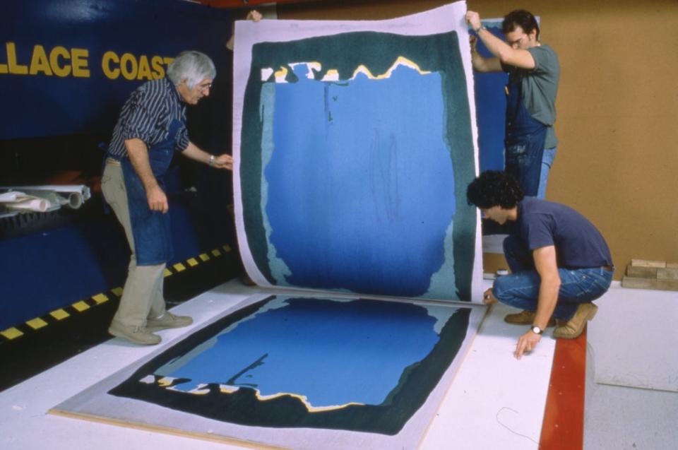 Kenneth Tyler, Robert Myer and Tom Strianese pulling proof impression from Helen Frankenthaler's 'Freefall' assembled woodblocks on hydraulic platen press in workshop, Tyler Graphics Ltd., Mount Kisco, New York, 1992. (Photo by Steven Sloman, 1992. Gift of Kenneth Tyler 2002. Courtesy: National Gallery of Australia.)