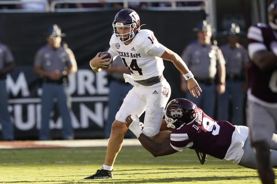 Texas A&M quarterback Max Johnson (14) is tackled by Mississippi State defensive end De'Monte Russell (9) during the second half of an NCAA college football game in Starkville, Miss., Saturday, Oct. 1, 2022. Mississippi State won 42-24. (AP Photo/Rogelio V. Solis)