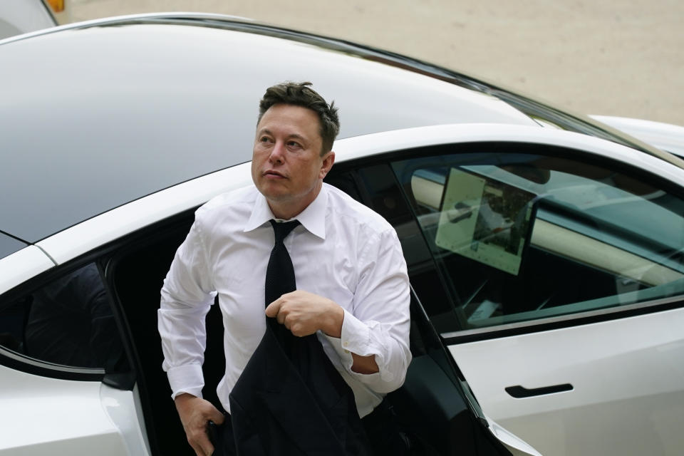 Elon Musk arrives at the justice center in Wilmington, Del., Tuesday, July 13, 2021. Musk took to a witness stand Monday to defend his company's 2016 acquisition of a troubled company called SolarCity against a shareholder lawsuit that claims he's to blame for a deal that was rife with conflicts of interest and never delivered the profits he had promised. (AP Photo/Matt Rourke)