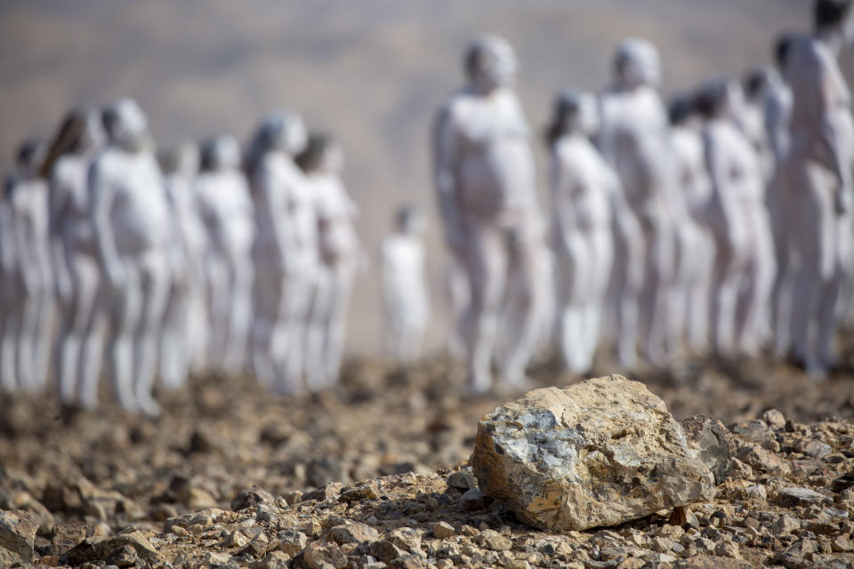 People pose nude for American artist Spencer Tunick as part of an installation in the desert near the Dead Sea, in Arad, Israel, Sunday, Oct. 17, 2021. About 300 participants took part in the nude photo installation designed to draw world attention to the importance of preserving and restoring the Dead Sea. (AP Photo/Ariel Schalit)