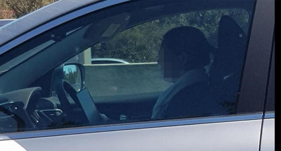 The woman was spotted driving down Perth’s Kwinana Freeway while appearing to use a laptop. Image: Facebook