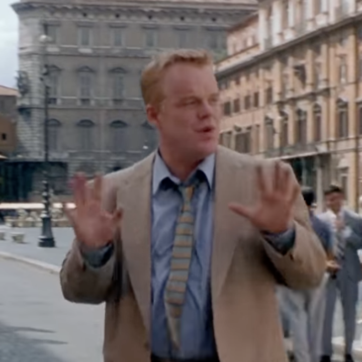 Hoffman as Freddie, wearing a suit walking through Rome