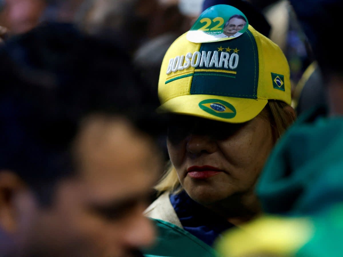 Supporters of Jair Bolsonaro wait to greet his return (Adriano Machado/Reuters)