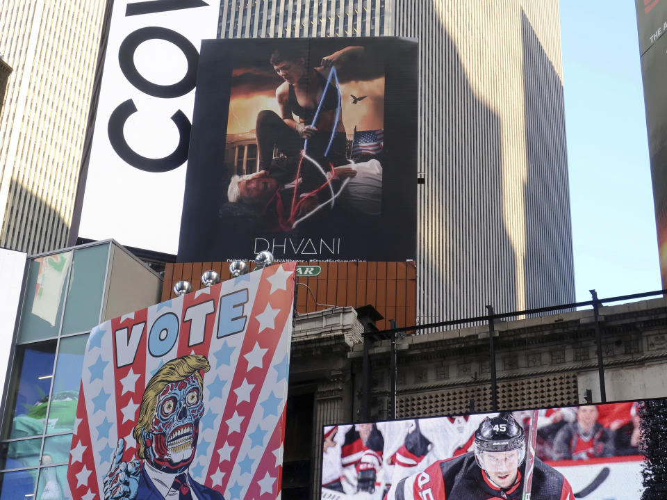A billboard in New York City's Time Square depicts President Donald Trump being hogtied by a woman clad in athletic wear on Friday, Oct. 18, 2019. The The 30-foot-high billboard is part of an advertising campaign by Dhvani, a Portland-based clothing company. CEO of Dhvani Avi Brown told The Associated Press the billboard was intended to be a comment on the Trump administration's changes to the Title X family planning program blocking federal funding for health providers who refer patients for abortions. (AP Photo/Ted Shaffrey)