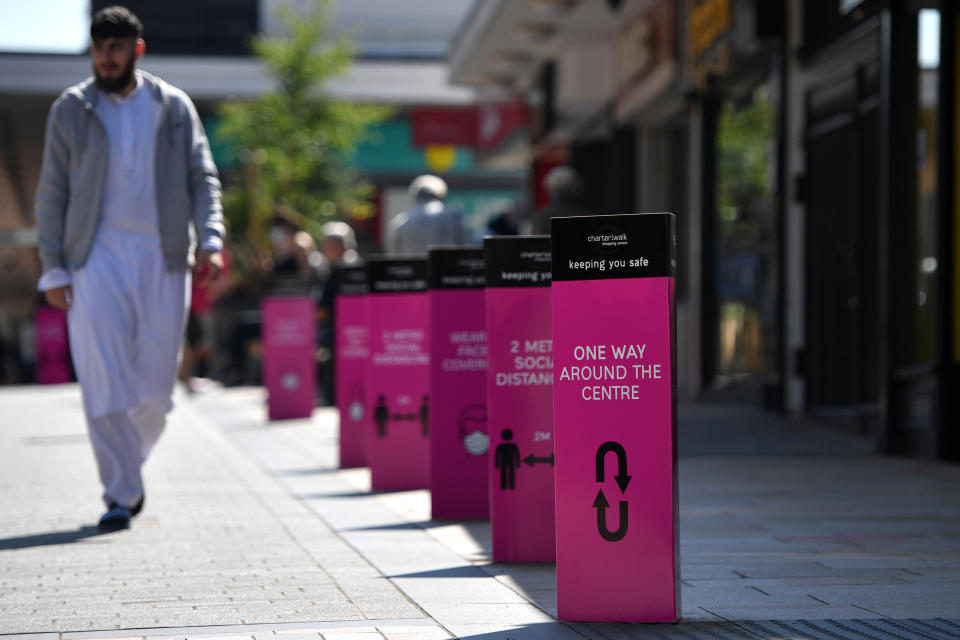 BURNLEY, ENGLAND - JULY 31: Social distancing signs are displayed in Burnley town centre on July 31, 2020 in Burnley, England. Lockdown has been heightened in parts of England with a restriction ban for separate households in parts of northern England from meeting each other at home. (Photo by Anthony Devlin/Getty Images)