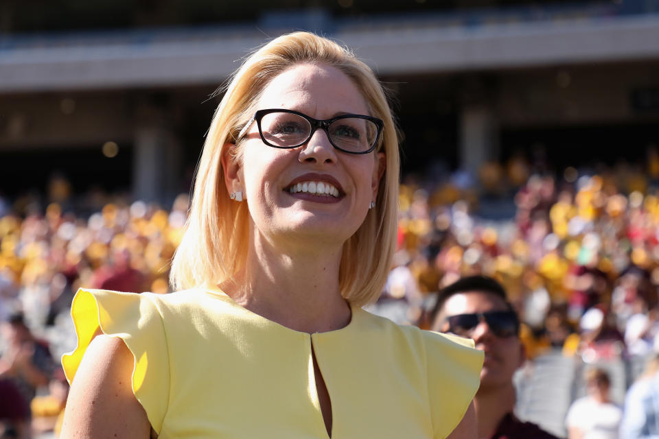 Democrat Senate candidate Kyrsten Sinema participates in the pregame coin toss before the game between the Utah Utes and the Arizona State Sun Devils on Nov. 3, 2018 in Tempe, Arizona.