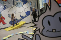 Ella Baldassano, 6, plays with her mother Ashley Baldassano in a play space at Big Snow during the grand opening in East Rutherford, N.J., Thursday, Dec. 5, 2019. The facility, which is part of the American Dream mega-mall, is North America's first indoor ski and snowboard slope with real snow. (AP Photo/Seth Wenig)