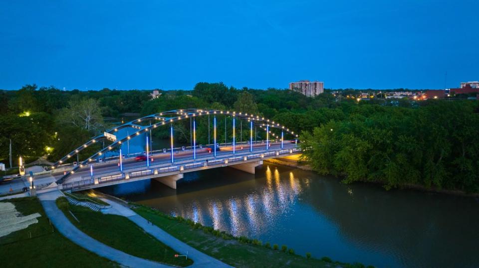 MLK bridge at dusk with night lights leading into Headwaters Park via Getty Images