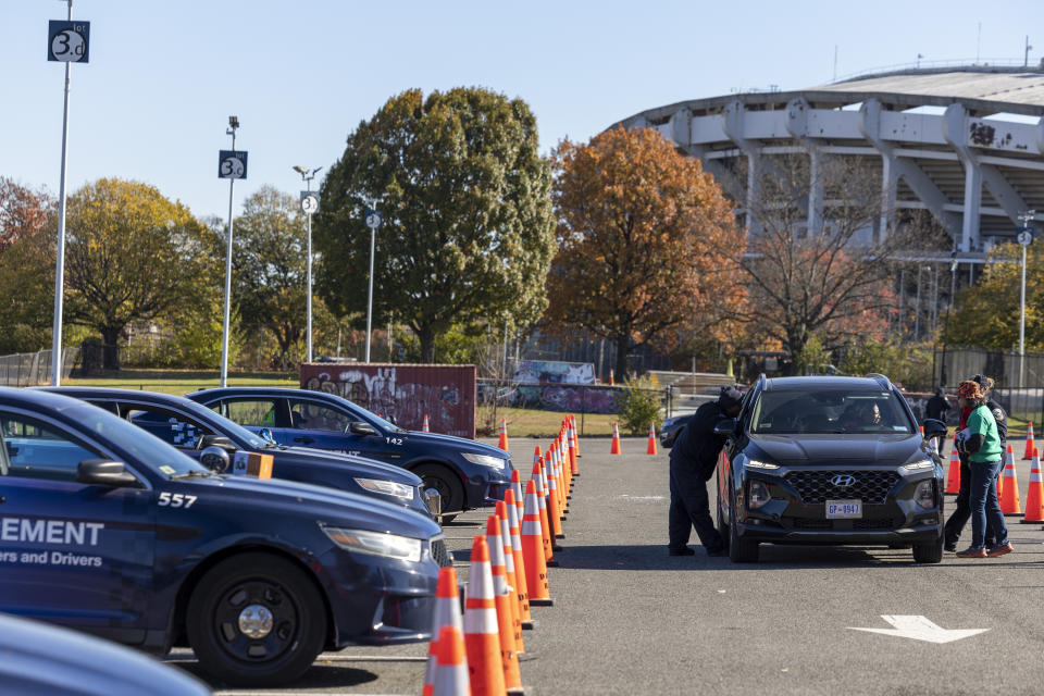 Drivers are given dashboard cameras during an event where they were distributed to drivers in an effort to combat a rise in crime, hosted in the parking lot of Robert F. Kennedy Stadium in Washington, Tuesday, Nov. 14, 2023. (AP Photo/Amanda Andrade-Rhoades)