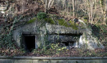 FILE - In this Monday, Dec. 14, 2015 file photo, a World War II bunker is embedded into a hillside above the River Meuse in Lanaye, Belgium. The bunker was used during the war by German troops in the defense of their positions along the river. It was 75 years ago that Hitler launched his last desperate attack to turn the tide for Germany in World War II. At first, German forces drove so deep through the front line in Belgium and Luxembourg that the month-long fighting came to be known as The Battle of the Bulge. (AP Photo/Virginia Mayo, File)