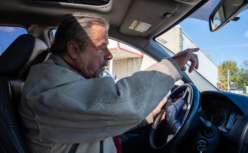 Gary Wagoner drives in his hometown, Union City, Indiana, on Wednesday, Nov. 3, 2021, to look for his sister, Linda Wagoner. He hasn't seen her in years. Here, Wagoner points in the direction of their old home.