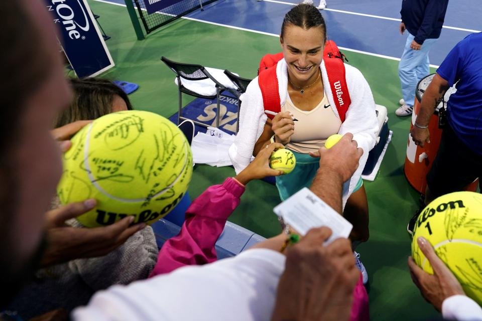 Aryna Sabalenka, of Belarus, gives autographs after winning her third-round match against Daria Kasatkina during the Western & Southern Open tennis tournament, Thursday, Aug. 17, 2023, at the Lindner Family Tennis Center in Mason, Ohio.