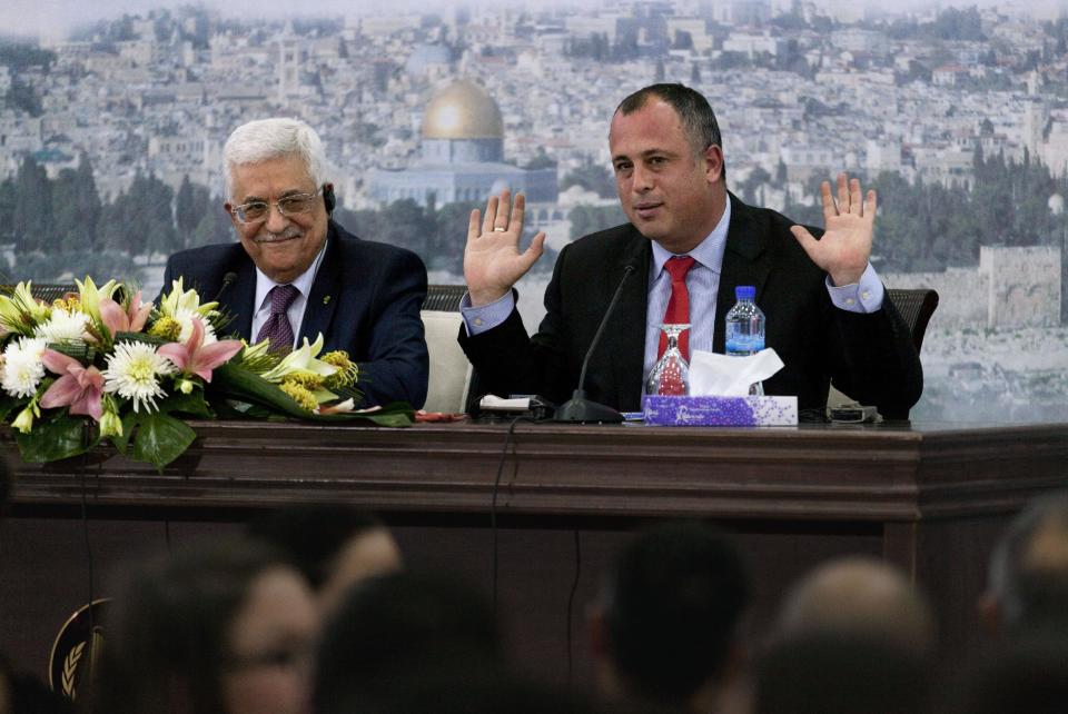 Palestinian President Mahmoud Abbas, left and Israeli Labor party lawmaker Hilik Bar attend a meeting with a delegation of mostly Israeli university students and activists at the presidential headquarters in the West Bank city of Ramallah, Sunday, Feb. 16, 2014. Abbas said that he does not want to "drown Israel with millions of (Palestinian) refugees to change its nature." Abbas' comment Sunday was his most conciliatory yet on the fate of Palestinian refugees who were uprooted from homes in what is now Israel, including in the 1948 war over Israel's creation. (AP Photo/Nasser Nasser)