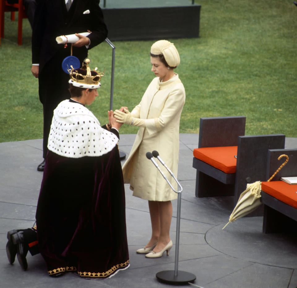 <p>Wearing a coordinated outfit complete with coat dress not dissimilar to one that the Duchess of Cambridge would wear today, the Queen is pictured here with Prince Charles at his Investiture as Prince of Wales in July 1969. <i>[Photo: Rex/Reginald Davis]</i></p>