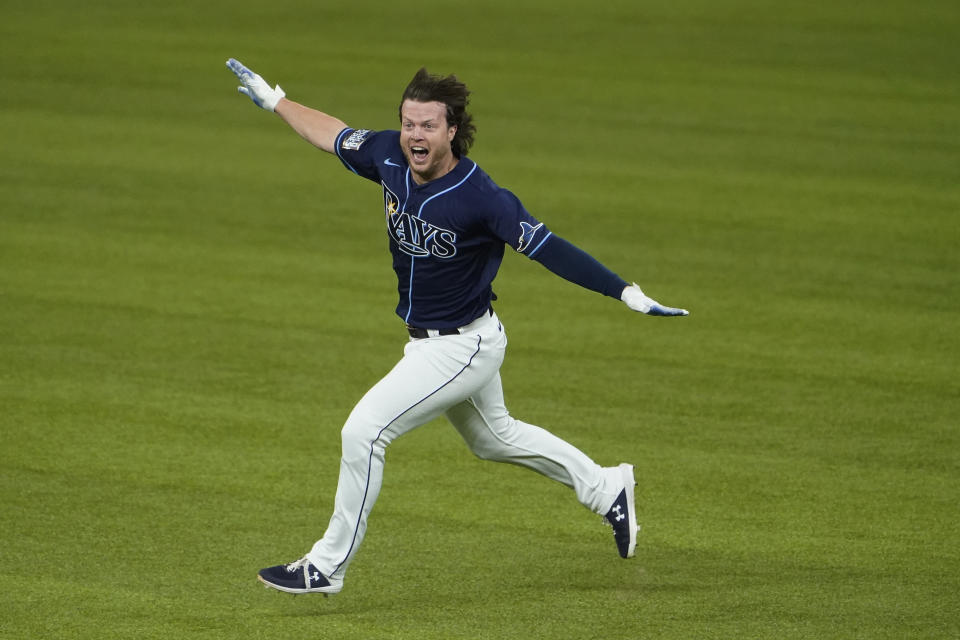 Tampa Bay Rays' Brett Phillips (14) celebrates the game winning hit against the Los Angeles Dodgers in Game 4 of the baseball World Series Saturday, Oct. 24, 2020, in Arlington, Texas. Rays defeated the Dodgers 8-7 to tie the series 2-2 games. (AP Photo/Tony Gutierrez)