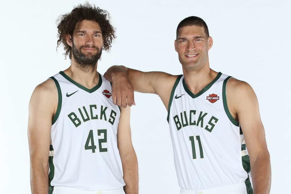 <p>Gary Dineen/NBAE/Getty</p> Robin Lopez #42 and Brook Lopez #11 of the Milwaukee Bucks pose for a portrait during Media Day on September 30, 2019.