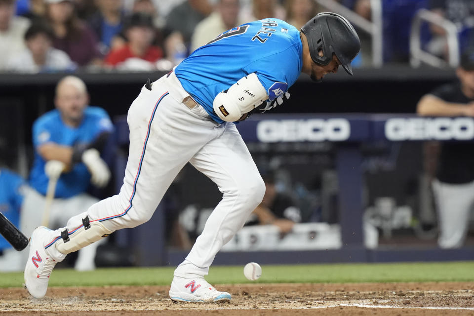 Miami Marlins' Luis Arraez grimaces after he was hit by a pitch during the third inning of a baseball game against the Los Angeles Angels, Wednesday, April 3, 2024, in Miami. (AP Photo/Marta Lavandier)