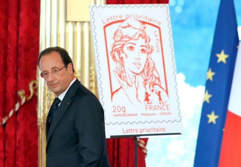 Former president Francois Hollande with the Marianne he chose emblazoned on a postal stamp