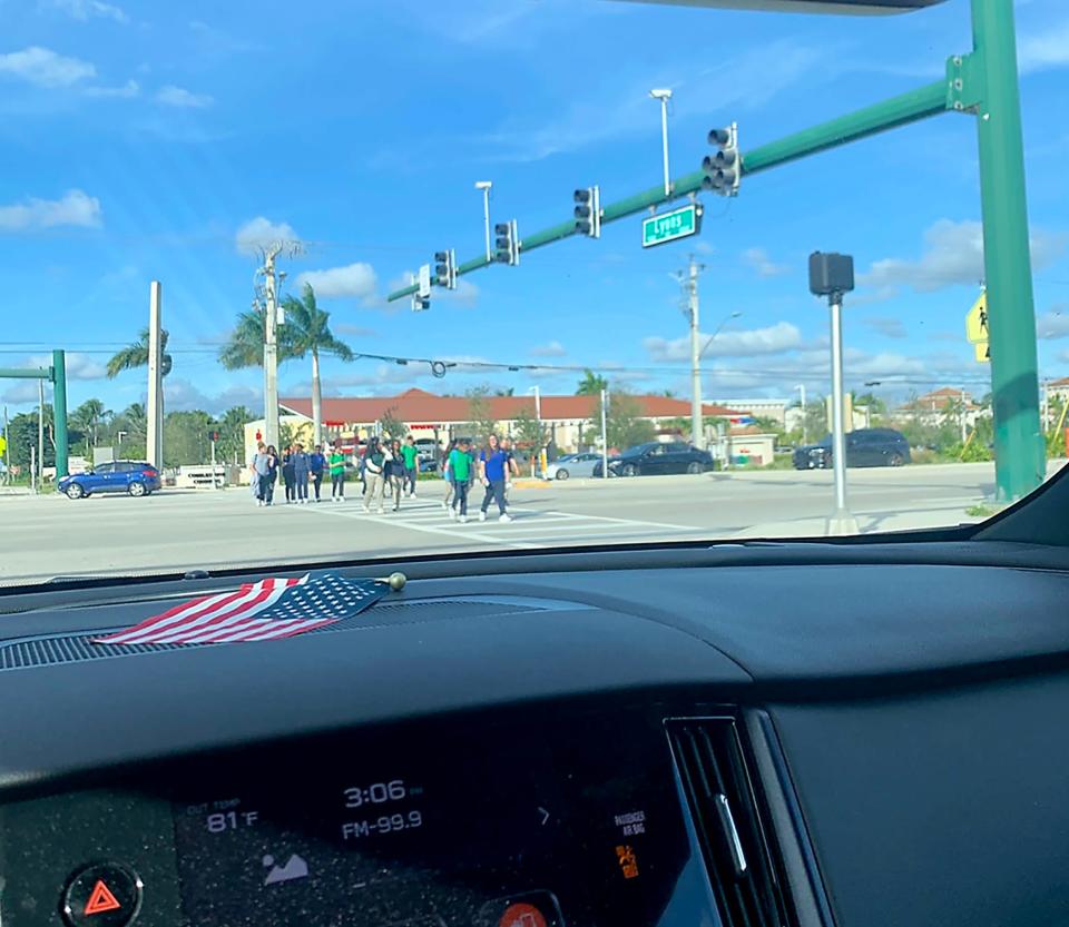 Students cross the intersection of Lyons Road and Boynton Beach Boulevard.