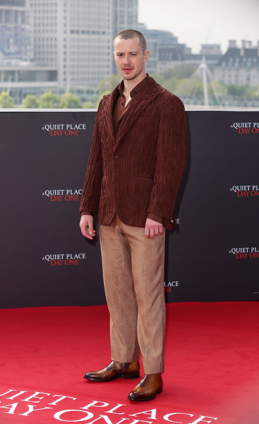joseph quinn with a shaved head at the a quiet place day one photocall