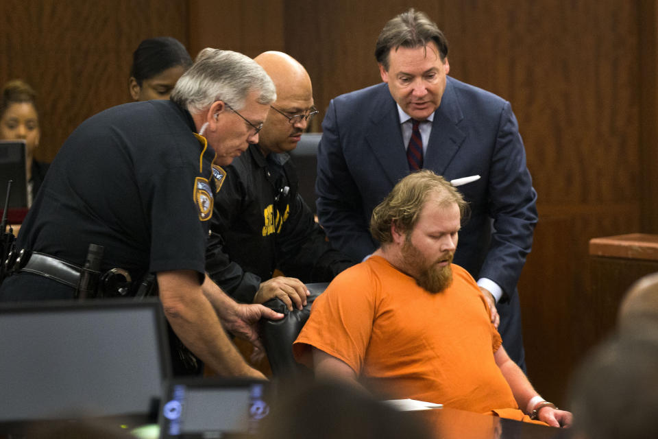 FILE - In this July 11, 2014 file photo, Ronald Lee Haskell collapses as he appears in court in Houston. Both the prosecution and the defense have rested in the trial of Haskell who's accused of fatally shooting six members of his ex-wife's family in suburban Houston in 2014. Closing arguments are expected Wednesday Sept. 25, 2019. (Brett Coomer/Houston Chronicle via AP, Pool)