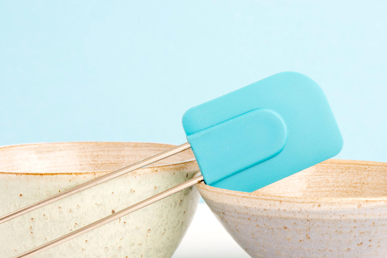 Kitchen bowl and dough scraper on table