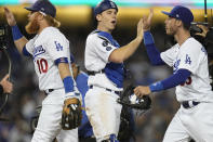 Los Angeles Dodgers congratulate each other at the end of Game 3 of baseball's National League Championship Series Tuesday, Oct. 19, 2021, in Los Angeles. The Dodgers defeated the Braves 6-5. The Braves lead the series 2-1 games. (AP Photo/Ashley Landis)