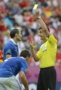 Italian defender Giorgio Chiellini (L) is given a yellow card by Hungarian referee Viktor Kassai during the Euro 2012 championships football match Spain vs Italy on June 10, 2012 at the Gdansk Arena. AFP PHOTO / PIERRE-PHILIPPE MARCOUPIERRE-PHILIPPE MARCOU/AFP/GettyImages