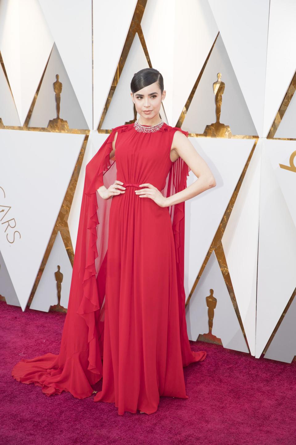 <p>Sofia Carson wears a gorgeous red dress designed by Giambattista Valli Resort and Chopard jewels and Jimmy Choo stilettos.</p>