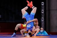 <p>Japan's Shohei Yabiku (blue) wrestles Kazakhstan's Demeu Zhadrayev in their men's greco-roman 77kg wrestling early round match during the Tokyo 2020 Olympic Games at the Makuhari Messe in Tokyo on August 2, 2021. (Photo by Jack GUEZ / AFP)</p> 