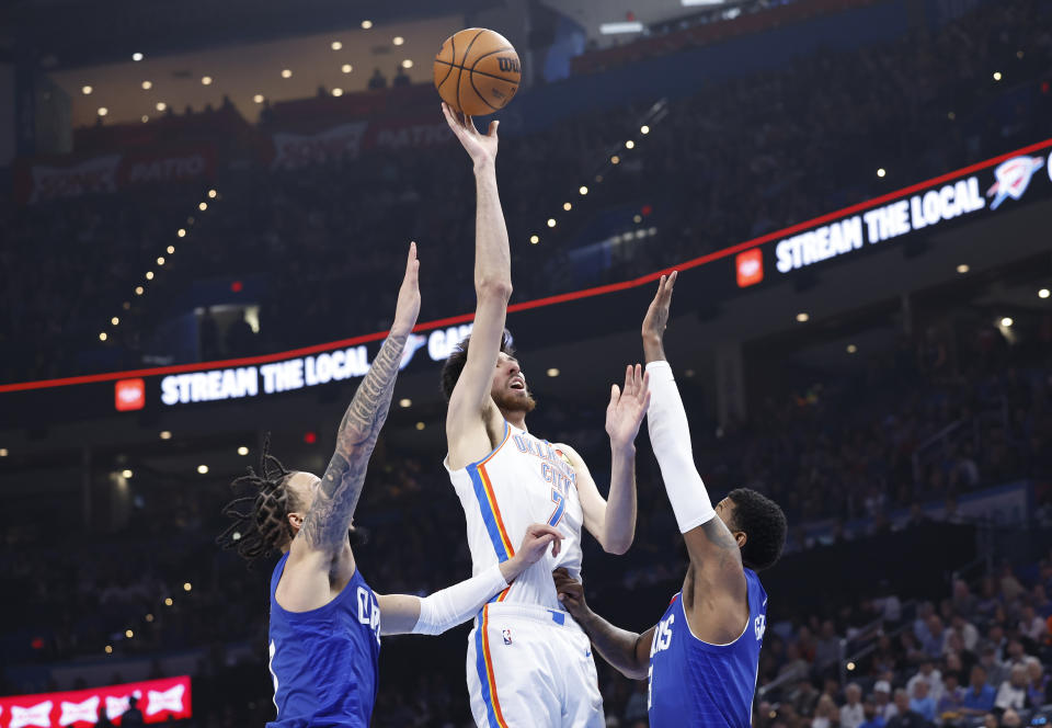 Feb 22, 2024; Oklahoma City, Oklahoma, USA; Oklahoma City Thunder forward <a class="link " href="https://sports.yahoo.com/nba/players/6692/" data-i13n="sec:content-canvas;subsec:anchor_text;elm:context_link" data-ylk="slk:Chet Holmgren;sec:content-canvas;subsec:anchor_text;elm:context_link;itc:0">Chet Holmgren</a> (7) shoots between LA Clippers guard <a class="link " href="https://sports.yahoo.com/nba/players/6315/" data-i13n="sec:content-canvas;subsec:anchor_text;elm:context_link" data-ylk="slk:Amir Coffey;sec:content-canvas;subsec:anchor_text;elm:context_link;itc:0">Amir Coffey</a> (7) and forward Paul George (13) during the second quarter at Paycom Center. Mandatory Credit: Alonzo Adams-USA TODAY Sports