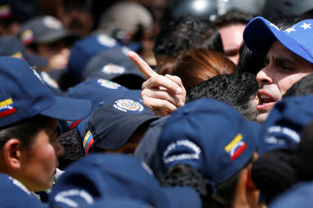 Venezuelan opposition leader and Governor of Miranda state Henrique Capriles (R) takes part in a rally against Venezuelan President Nicolas Maduro's government and to commemorate the 59th anniversary of the end of the dictatorship of Marcos Perez Jimenez in Caracas, Venezuela January 23, 2017. REUTERS/Carlos Garcia Rawlins