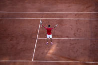 Serbia's Novak Djokovic raises his arms in victory after defeating Stefanos Tsitsipas of Greece during their final match of the French Open tennis tournament at the Roland Garros stadium Sunday, June 13, 2021 in Paris. Djokovic 6-7, 2-6, 6-3, 6-2, 6-4.(AP Photo/Christophe Ena)