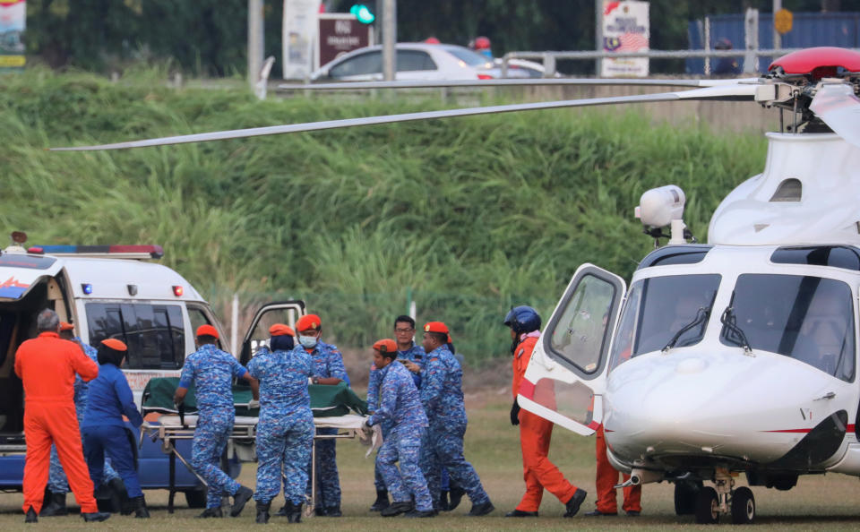 A body believed to be 15-year-old Irish girl Nora Anne Quoirin who went missing is brought out of a helicopter in Seremban, Malaysia.