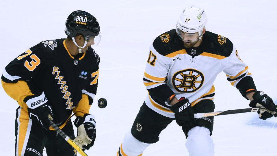 Pittsburgh Penguins' Pierre-Olivier Joseph (73) and Boston Bruins' Nick Foligno (17) try to control the puck during the first period of an NHL hockey game Tuesday, Nov. 1, 2022, in Pittsburgh. (AP Photo/Keith Srakocic)