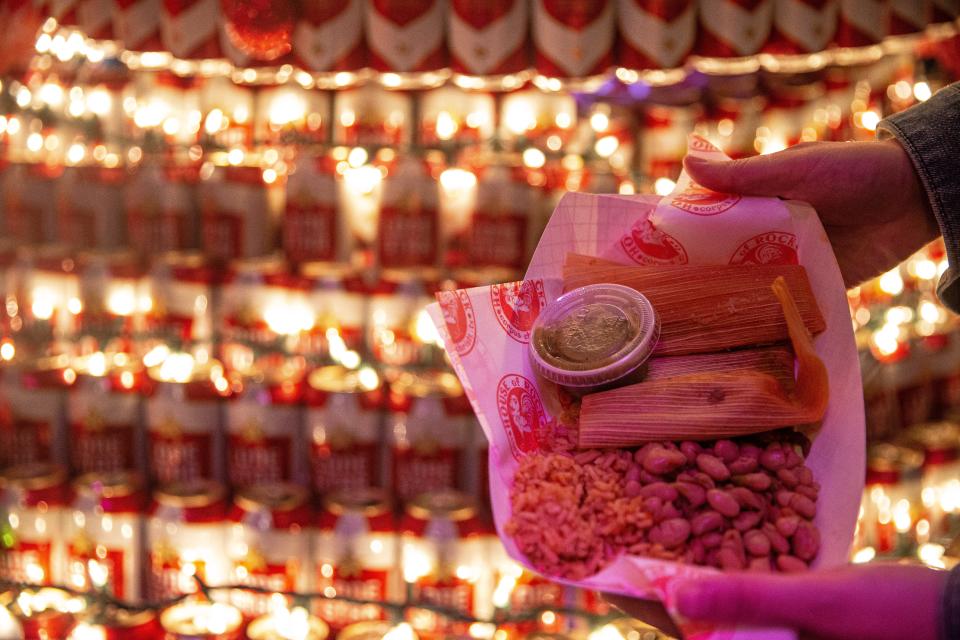 House of Rock serves customers two tamales, charro beans and rice on Friday, Dec. 24, 2021, during the bar's 17th annual free Tamale Dinner.