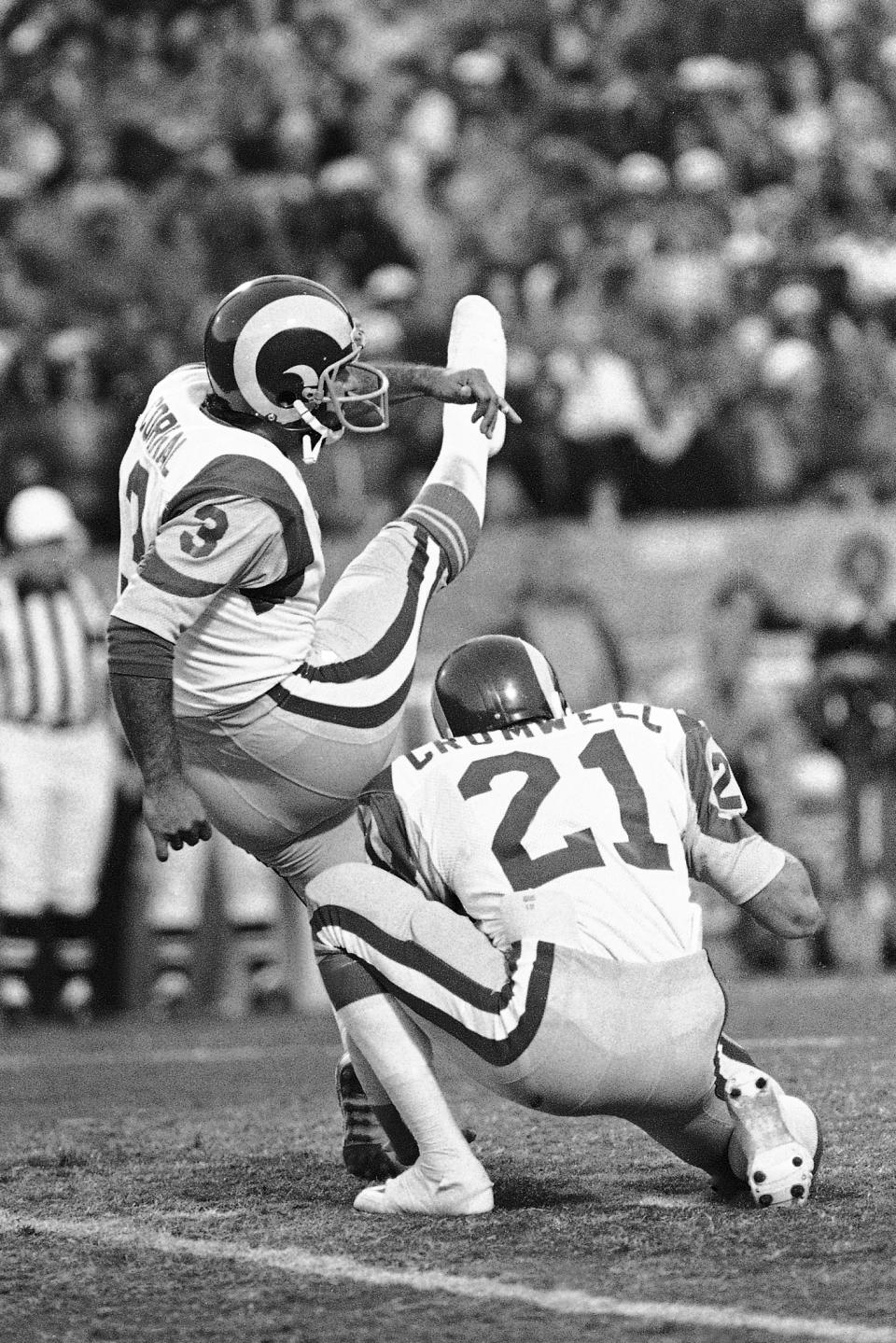 FILE - In this Jan. 7, 1980, file photo, Frank Corral (3) of the Los Angeles Rams, kicks his third and final field goal against the Tampa Bay Buccaneers in the NFC Championship NFL football game in Tampa, Fla. Holding is Nolan Cromwell (21). Los Angeles beat Tampa 9-0 on three field goals. (AP Photo/File)