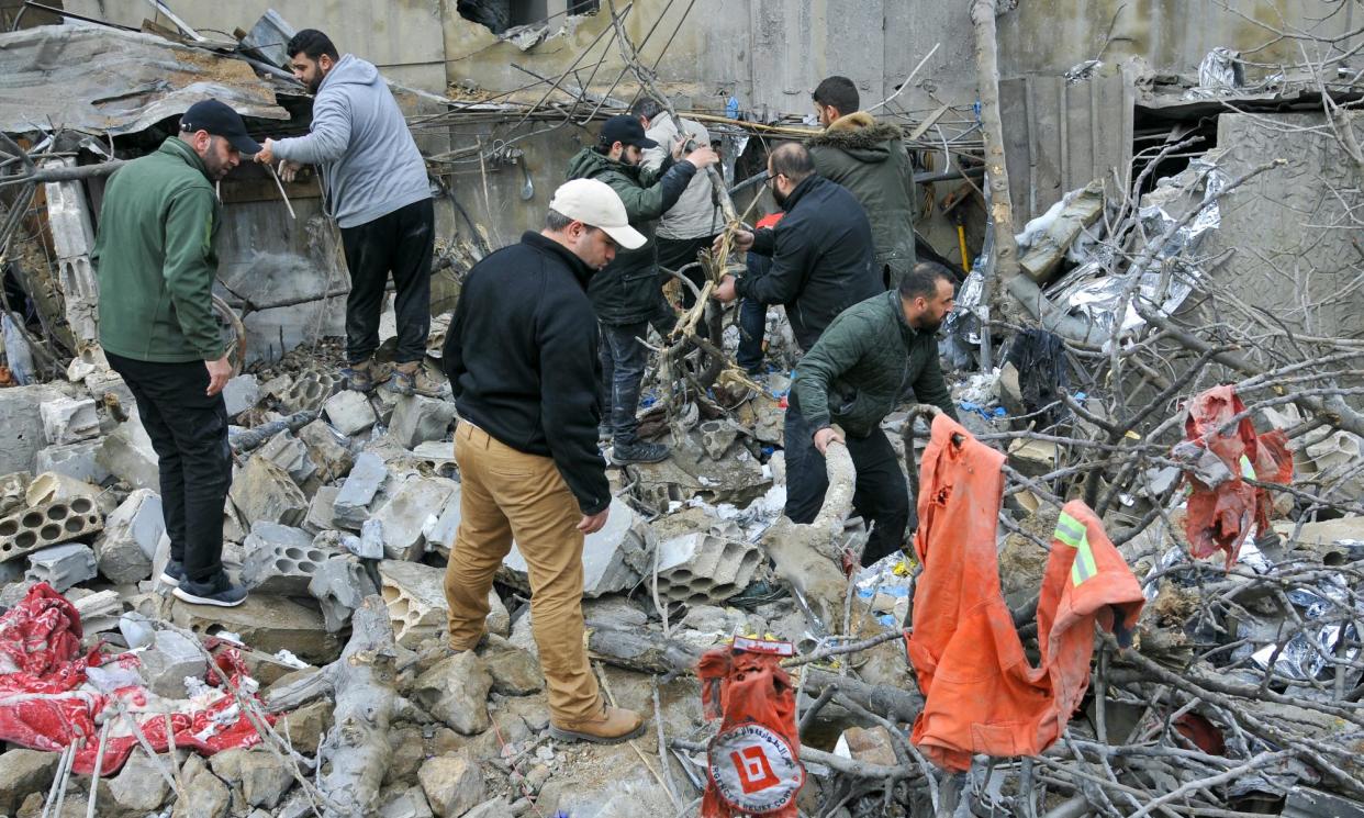 <span>Workers inspect destruction at the site of an Israeli airstrike in Habariyeh near the Israeli border on 27 March 2024.</span><span>Photograph: Rabih Daher/AFP/Getty Images</span>