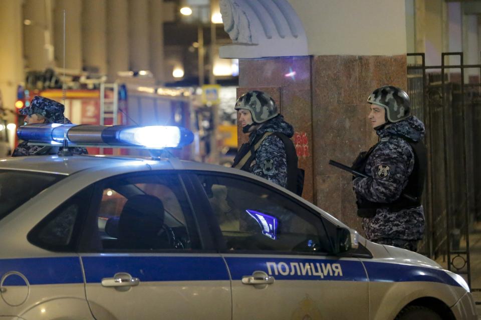 Russian police officers secure the area near the building of the Federal Security Service (FSB, Soviet KGB successor) in the background in Moscow, Russia, Thursday, Dec. 19, 2019. Russian officials say an officer of Russia's main security agency has been killed by an unidentified gunman near its Moscow headquarters and five others have been injured. (AP Photo/Alexander Zemlianichenko Jr)