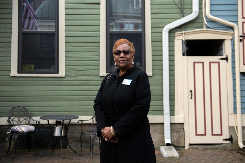 Jane Fox Long, a 4th great granddaughter to Revolutionary War soldier Oliver Cromwell, poses on the street in which he lived Wednesday, April 27, 2022 in Burlington City, NJ.